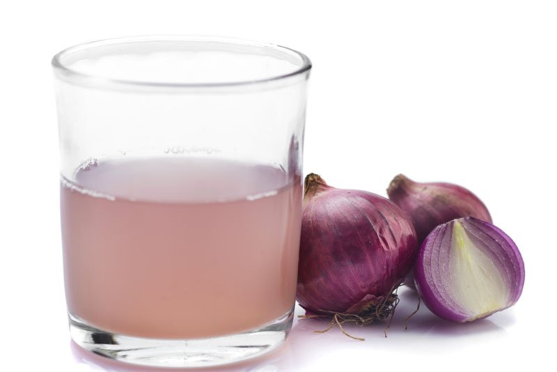 Glass of onion juice and onions